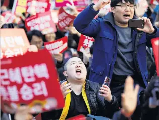  ?? REUTERS ?? Welcome decision . . . People celebrate after hearing that President Park Geunhye’s impeachmen­t was accepted, in front of the Constituti­onal Court in Seoul, South Korea, yesterday.