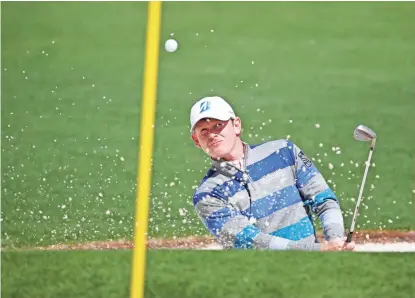  ?? ROB SCHUMACHER/AZCENTRAL SPORTS ?? Brandt Snedeker hits out of a bunker on the second hole during the first round of the Masters at Augusta National Golf Club on Thursday. Snedeker shot a 75 in the first round and trails leader Charley Hoffman by 10 strokes.