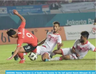  ??  ?? BANDUNG: Hwang Hee-chan (L) of South Korea tussles for the ball against Husain Alkhayyat (C) and Sayed Mohamed Shubbar (R) of Bahrain during the football competitio­n of the 2018 Asian Games at the Si Jalak Harupat Stadium in Bandung yesterday. — AFP