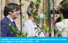  ?? — AFP ?? ALGHERO: Exiled former Catalan president Carles Puigdemont arrives for a convention in Alghero, on the island of Sardinia.