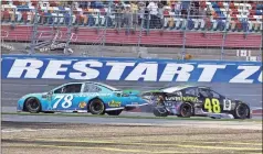  ?? AP - Chuck Burton, file ?? Martin Truex Jr. (78) and Jimmie Johnson crash in a 2018 race at Charlotte Motor Speedway. Charlotte will host two races over a four-day span in May.