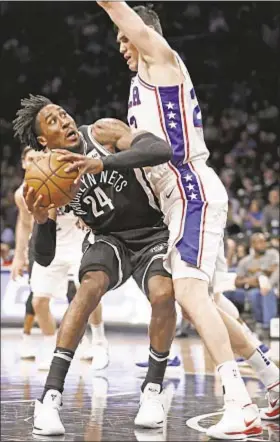  ?? AP ?? Nets’ Rondae Hollis-Jefferson finds path blocked by Sixers’ Ersan Ilyasova.