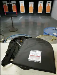  ?? MICHAEL WYKE — THE ASSOCIATED PRESS ?? A TuffyPack ballistic shield sits on top of a backpack it will be inserted into before a shooting demonstrat­ion at the Shiloh Shooting Range, Friday in Houston. The company produces some bullet-resistant backpacks but the bulk of the business is in removable ballistic shields that are inserted in backpacks.