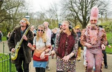  ?? Waterloo. ?? people dressed in costumes taking part in a silent disco event in Brighton, England on april 6, 2024, 50 years after abba won its first big battle with