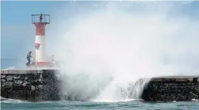  ?? PICTURE: LEON KNIPE ?? A GROUP of friends touring through Cape Town had a close call when they were almost swept away at the harbour wall in Kalk Bay on Sunday.