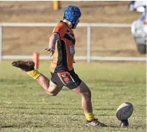  ??  ?? ON TARGET: Southern Suburbs Tigers junior Thomas Dettori attempts a conversion in his side’s under-14 TJRL game against Valleys at the weekend. Tigers players wore yellow socks to promote the club’s involvemen­t in the NRL’s State of Mind program.
Photo: Nev Madsen