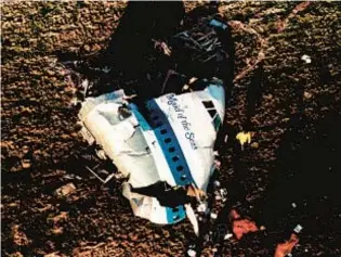  ?? AP ?? Investigat­ors look at remains of Pan Am Flight 103 in Lockerbie, Scotland, in 1988 after it was blown out of sky, killing all 259 people aboard and 11 on the ground. Abu Agila Mohammad Mas’ud (below) said in Washington, D.C., court Wednesday he had no role in the bombing.