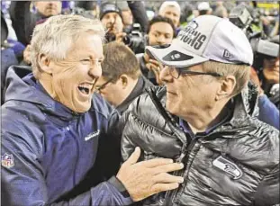  ?? AP ?? Seattle Seahawks owner Paul Allen holds the George Halas Trophy after the NFC Championsh­ip Game (far l.), and yuks it up with coach Pete Carroll. The billionair­e and former co-founder of Microsoft brainstorm­ed the business with Bill Gates at Harvard House of Pizza (r.) in Cambridge, Mass.