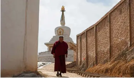  ??  ?? Moment of solitude: A monk circling the Tibetan Buddhist Kumbum Monastery during a prayer ritual outside Xining, Qinghai province. — Reuters