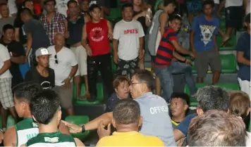  ?? Chris Navarro ?? RUMBLE! A basketball official tries to shield a referee from an angry Apalit crowd after a controvers­ial call which resulted in a one point win for Team Guagua during Thursday's NLEx Basketball Cup Intertown at the Bren Z. Guiao Convention Center...