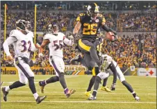  ?? AP PHOTO ?? Pittsburgh Steelers running back Le’Veon Bell leaps into the end zone ahead of Baltimore Ravens strong safety Eric Weddle for a touchdown during the second half of a game in Pittsburgh.