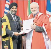  ?? STEVEN MCQUAID/DND-CAF ?? Harjit Singh Sajjan, minister of National Defence and Chancellor of Royal Military College, confers an honorary degree doctor of science to Phillip Somers, Lt.-Col. retired, at the Royal Military College of Canada’s recent convocatio­n ceremonies in...