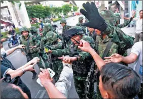  ?? The Associated Press ?? Thai soldiers scuffle with protesters Saturday during an anti-coup demonstrat­ion at the Victory Monument in Bangkok, Thailand.