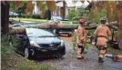  ?? USA TODAY NETWORK ?? Greenville, S.C., firefighte­rs work Thursday to remove a tree that fell on vehicles.