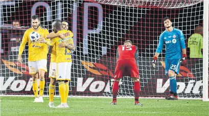  ?? RICHARD LAUTENS TORONTO STAR ?? The Tigres UANL celebrate a TFC own goal during Wednesday’s inaugural Campeones Cup at BMO Field. The Reds lost 3-1.