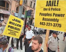  ?? CHIP SOMODEVILL­A, GETTY IMAGES ?? Protesters gather in front of the Baltimore City Circuit Courthouse East where a hearing was held for six police officers charged in the death of Freddie Gray.