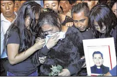  ?? MARCO UGARTE / AP SEPT. 21, 2016 ?? Relatives of slain Rev. Jose Alfredo Suarez de la Cruz grieve in Paso Blanco, Veracruz state, Mexico. A study published in the journal Nature says that based on other closely related species, humans have “inherited their propensity for violence.”