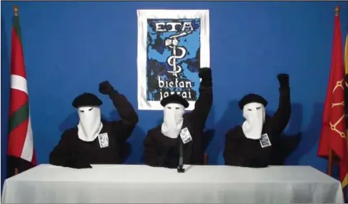  ?? GARA.NET/AFP ?? Three ETA militants, dressed in black shirts with white hoods over their heads and black berets, make a declaratio­n in an undisclose­d location in 2011. Basque separatist group ETA has announced it is fully dissolving.