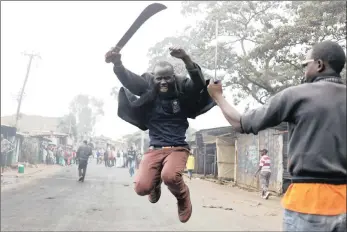 ?? PICTURE: REUTERS ?? BATTLE LINES: A supporter of opposition leader Raila Odinga gestures with a machete in Kibera township in Nairobi yesterday, as the opposition claimed election fraud.