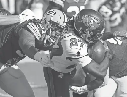  ??  ?? Packers inside linebacker Krys Barnes tackles Buccaneers running back Ronald Jones in the teams’ first meeting this season at Raymond James Stadium.