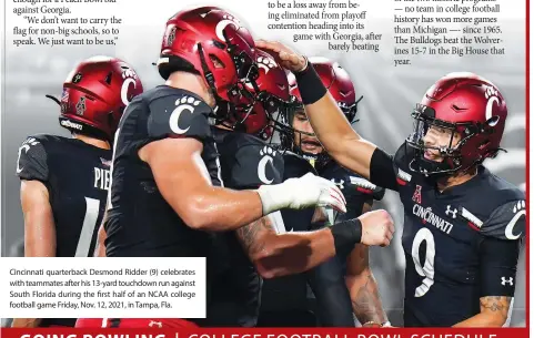  ?? ?? Cincinnati quarterbac­k Desmond Ridder (9) celebrates with teammates after his 13-yard touchdown run against South Florida during the first half of an NCAA college football game Friday, Nov. 12, 2021, in Tampa, Fla.