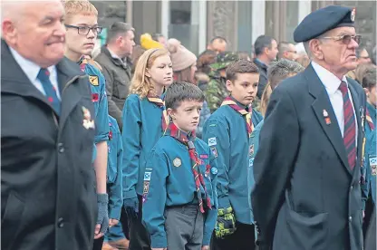  ?? Pictures: Paul Reid/paul Smith. ?? Top: A cannon is fired at the Remembranc­e parade at Arbroath War Memorial. Above: Scouts on parade at the wreath-laying ceremony in Forfar.