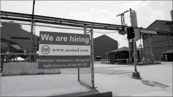  ?? ASSOCIATED PRESS ?? IN THIS JUNE 28 FILE PHOTO, a help wanted sign hangs outside the U.S. Steel Granite City Works facility in Granite City, Ill.