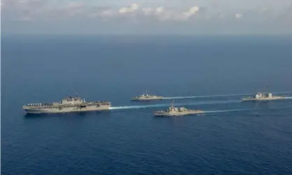  ?? Photograph: Australian Department of Defence/Reuters ?? Australian and US ships conduct manoeuvres in the South China Sea, in an image released in April 2020.