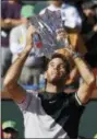  ?? MARK J. TERRILL — THE ASSOCIATED PRESS ?? Juan Martin del Potro holds up his trophy after defeating Roger Federer during the men’s final at the BNP Paribas Open tennis tournament, Sunday in Indian Wells, Calif.