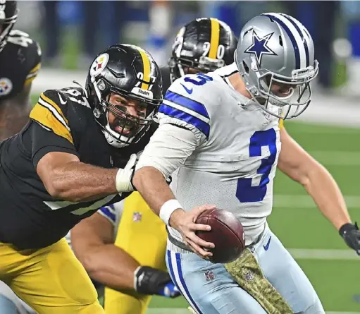  ?? Peter Diana/Post-Gazette ?? Steelers defensive lineman Cameron Heyward wraps up Cowboys quarterbac­k Garrett Gilbert on Nov. 8 at AT&T Stadium in Arlington, Texas. The Steelers are closing in on multiple sack records.