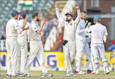  ?? BCCI ?? Virat Kohli and Mohammad Shami celebrate with teammates after India beat South Africa by 63 runs in the third Test on Saturday.