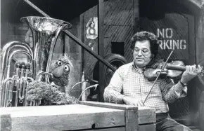  ?? Sesame Workshop photos via New York Times ?? Itzhak Perlman plays alongside the Muppet Telly.