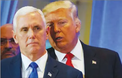  ?? The Associated Press ?? President-elect Donald Trump talks to Vice President-elect Mike Pence during a news conference in the lobby of Trump Tower.