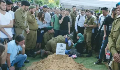  ?? (Marc Israel Sellem/The Jerusalem Post) ?? SGT. ELIYAHU DRORI, 22, an American-born soldier from Beit Shemesh, is buried at the Mount Herzl Military Cemetery in Jerusalem on Sunday.