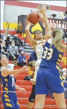  ?? Staff photo/ Jake Dowling ?? New Bremen’s Kaylee Freund leaps over the hand of St. Marys’ Karsyn McGlothen ( 33) in the first half of a non-league girls basketball game on Tuesday at New Bremen High School.