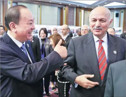  ?? FENG YONGBIN / CHINA DAILY ?? Huang Kunming, a member of the Political Bureau of the Communist Party of China Central Committee and head of the Publicity Department of the CPC Central Committee, and Pakistani Senator Mushahid Hussain Sayed interact on Dec 11, the final day of a human rights forum in Beijing.