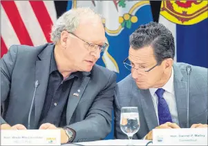  ?? CP PHOTO ?? P.E.I. Premier Wade MacLauchla­n, left, talks with Connecticu­t Governor Dannel Malloy at the closing news conference of a meeting of New England governors and Eastern Canadian premiers in Charlottet­own on Monday.