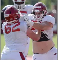  ?? (NWA Democrat-Gazette/Andy Shupe) ?? Arkansas offensive linemen Dalton Wagner (right) and Brady Latham lock up during a drill Tuesday in Fayettevil­le. It was the Razorbacks’ first full-contact workout of fall drills. More photos available at arkansason­line.com/826practic­e.