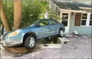  ?? PHOTO BY ROK H. HYON ?? Ida’s floodwater­s pushed this car into a home along Skippack Pike.