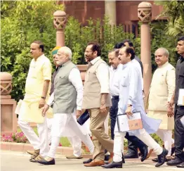  ?? — PRITAM BANDYOPADH­YAY ?? Prime Minister Narendra Modi along with Union ministers Ananth Kumar, Mukhtar Abbas Naqvi and other MPs leave after the BJP parliament­ary party meeting at Parliament Library Building in New Delhi on Friday.