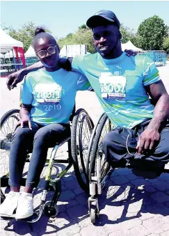  ?? PHOTO BY JASON CROSS ?? Navardo Griffiths embraces his teammate, Sashagaye Thompson, following their participat­ion in Sunday’s Sagicor Sigma Corporate Run in New Kingston. Griffiths was second in the 5K race for male para athletes.