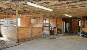 ??  ?? The renovated barn includes three stalls with the possibilit­y of up to six, tack room, feed room and a concrete floor.