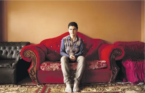  ?? MAYA ALLERUZZO/ THE ASSOCIATED PRESS ?? Syrian Hasib Rifat Moustafa, 16, sits in the apartment he shares with his sister’s family in the Middle East on Feb. 27. His mother and four of his siblings joined his father in the U.S. in July 2016.