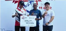  ?? ?? (From left) Abdul Karim presents a mock cheque for RM2,000 to Kenyan runner Lukas Mutati for winning the men’s division, with Next Phase Sdn Bhd director Yu Ji looking on.