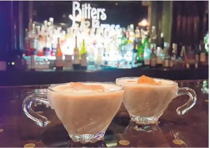  ?? PHOTOS BY LAUREN DELGADO/STAFF ?? Coquito, a rum-based coconut drink that’s eggnoglike but kicked up a notch, is served at Bitters & Brass.