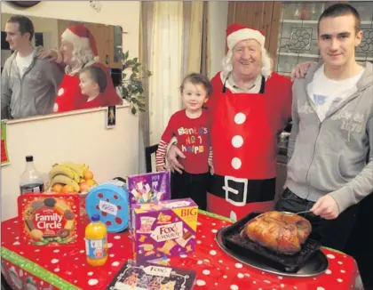  ??  ?? Bill Burke still going strong after 21 years cooking the Knights of Columbanus Christmas dinner but with a little help from his grandsons Liam Burke and Eden Doyle.