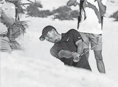  ?? FERNANDO LLANO/AP ?? Rory Mcilroy hits out of a bunker on the fifth hole during the first round of the Hero World Challenge Thursday at the Albany Golf Club in New Providence, Bahamas.