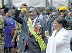  ?? THE ASSOCIATED PRESS FILES ?? Zimbabwe’s President Emmerson Mnangagwa, centre, is taking steps to differenti­ate himself from his ousted mentor, Robert Mugabe, as he tries to win over the country before next year’s elections.