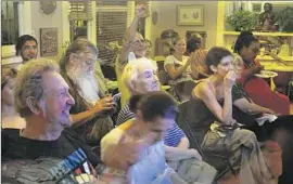  ?? Lawrence K. Ho
Los Angeles Times ?? BERNIE SANDERS supporters at the Los Angeles home of Lyn Pestana enjoy the debate, during which Sanders received several rounds of thunderous applause.