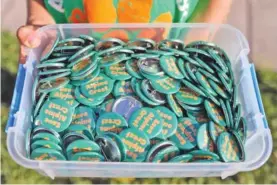  ?? ?? “Save Alpine Crest” buttons are handed out at an August meeting where the community advocated to save Alpine Crest Elementary from closure.